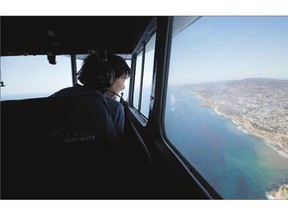 Lynda Jenner smiles, above, while sitting in the gondola of Goodyear's Spirit of America blimp, near Long Beach, California. The Goodyear Blimp is retiring, to be replaced by a similar-looking craft, a semi-rigid dirigible, which is technically not a blimp. Matthew St. John, photo at right, a pilot of Goodyear's Spirit of America blimp, walks toward the blimp at the Goodyear Airship Operations base, in Carson, California.