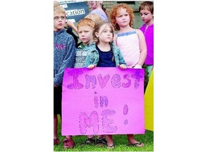 Maliya Nicholls, 5, holds a sign during a Thursday rally to protest provincial funding See Officer, A2 to the Prairie Spirit School Division in Martensville. See story on Page A4. See STF, A2