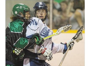 Manitoba Blizzard Keenan Koswin, right, is hit by Saskatchewan Swat Brody Jorgenson in Jr B lacrosse action on Sunday. The Blizzard won 14-10 as the Swat, which finished second in its division, heads into a best-of-three semifinal playoff series with one of two Calgary teams. .