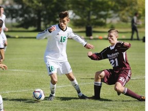 Marcello Gonzalez of the University of Saskatchewan Huskies, left, duels for the ball with Daniel Sperling of Grant MacEwan Griffins in action at the University of Saskatchewan on Friday.