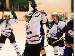 Matt Spafford, shown here celebrating a goal last season with teammates Jesse Ross, right, and Jesse Forsberg, left, is one of two fifth-year U of S Huskies this season.