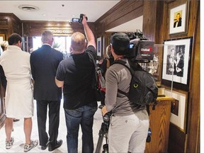 Media ask questions of club members and staff while being asked to leave the Cambridge Club in Toronto on Wednesday.