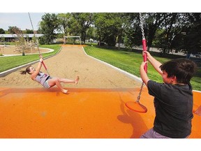 Megan Potter and Braxton Chatterson ride the zip line at the PotashCorp Playland at Kinsmen Park, which was open to the sponsor's employees and their children on Tuesday.