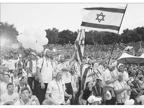 Members of the Israeli national team arrive at the official opening ceremony of the European Maccabi Games on Tuesday in Berlin, Germany. Over 2,000 Jewish athletes from Maccabi clubs all over the world will compete for the next week in Berlin, where in 1936 Nazi Germany held the Olympics and excluded its own Jewish athletes.