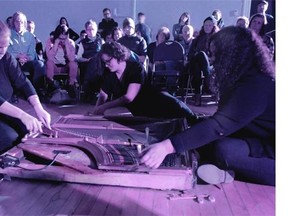 The members of Winnipeg group Burden perform on an amplified piano sound board. Burden perform at the Sounds Like Audio Art Festival on Saturday.