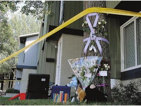 A memorial was set up outside an Oakview Drive home where a family of three lived and were discovered dead in 2010. Police say they have clues, but not enough to make an arrest.