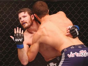 Michael Bisping appeals to the referee after being cut above the eye by Luke Rockhold in their middleweight fight during the UFC Fight Night 55 event at Allphones Arena in 2014 in Sydney.