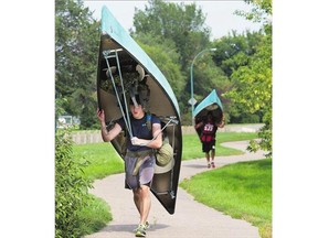 Pte. Michael Coquet and other participants were using the Meewasin Trail in Saskatoon on Friday as they trained for the military Mountain Man Marathon. Here, they're portaging canoes upriver between Ravine Drive and the CP Rail Bridge.