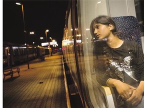 A migrant looks out of a window on a train from Budapest to Munich at the Austrian-Hungarian border in the Hungarian village of Hegyeshalom on Monday. w