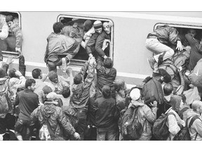 Migrants desperately try to board a train heading for Zagreb from Tovarnik station early Monday in Tovarnik, Croatia.