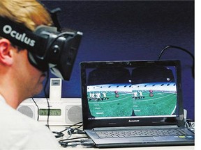 Mississippi quarterback Ryan Buchanan uses a virtual reality headset to make play decisions. Teams are dabbling in the technology to help supplement work on the field.