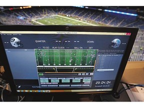 A monitor above Ford Field shows stats and movement for players and officials during warm-ups before Thursday's pre-season game between the New York Jets and Detroit Lions.