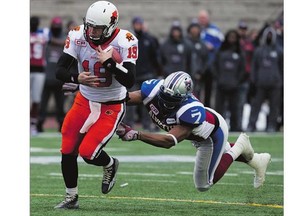 Montreal Alouettes defensive end John Bowman, right, grabs hold of B.C. Lions quarterback Travis Partridge at Molson Stadium in Montreal. The 10-year veteran says he thought some of ex-head coach Tom Higgins' comments were 'unfair.'