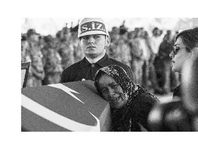 The mother of Turkish soldier Mehmet Yalcin Nane cries during his burial ceremony on Friday in Gaziantep. Turkish fighter jets on Friday bombed ISIL positions inside Syria for the first time, as police arrested hundreds of suspected extremists after a wave of violence.