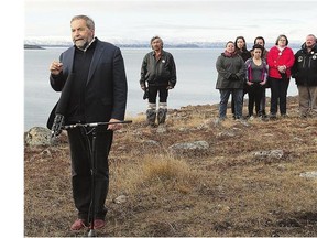 Tom Mulcair, joined by supporters, speaks during a campaign stop in Nunavut on Wednesday. Polling numbers suggest the NDP is losing favour among voters seeking change.