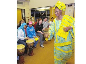 Muna DeCiman, of The Daughters of Africa, teaches African drumming to students at F.W. Johnson Collegiate in Regina.