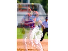 Netherlands pitcher Jeffry Visser throws a pitch against team Great Britain during the Men’s World Softball Championships at Bob Van Impe Stadium in Saskatoon on Friday, July 3rd, 2015. This photo is a in camera multiple exposure of a collection of images layered over one another while the photograph is taken.