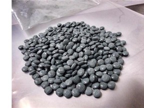 Four men are in Saskatoon police custody after two searches turned up guns, cash and what are believed to be fentanyl pills.
