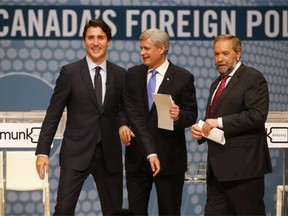 Liberal Leader Justin Trudeau, left to right, Conservative Leader Stephen Harper and NDP Leader Tom Mulcair leave the stage following the Munk Debate on Canada's foreign policy in Toronto, on Monday, Sept. 28, 2015.