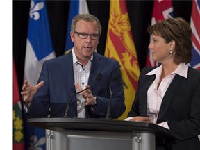 Saskatchewan Premier Brad Wall, left, and British Columbia Premier Christy Clark field questions at the summer meeting of Canada's premiers in St. John's on Friday, July 17, 2015. THE CANADIAN PRESS/Andrew Vaughan  Brad Wall Christy Clark