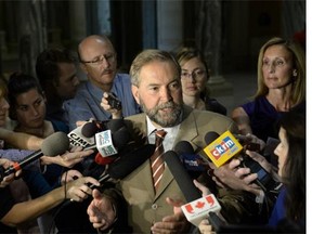 Federal NDP leader Tom Mulcair speaks with reporters after meeting with Saskatchewan Premier Brad Wall in Regina on Sept. 9, 2013
