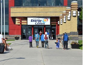 A Red Cross volunteer opens the Energy Centre doors to greet evacuees arriving in Cold Lake on July 5. The evacuees are from La Ronge, Sask., where wildfires threaten nearby communities
