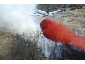 An airplane drops chemicals on a forest fire in the La Ronge area, one of 116 fires burning in Saskatchewan in October, 2015.