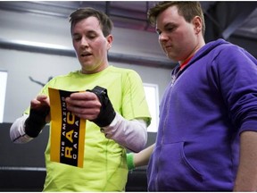 Brothers Brent, left, and Sean Sweeney receive an Amazing Race Canada clue after completing a challenge at the Apex Trampoline Park in Saskatoon.