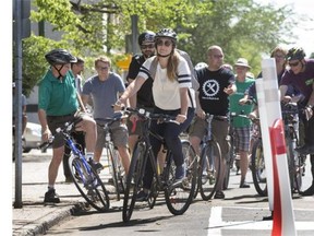 A choir of bike bells rang in celebration as city officials gathered to launch the city’s enclosed bike lane on 23rd Street East.