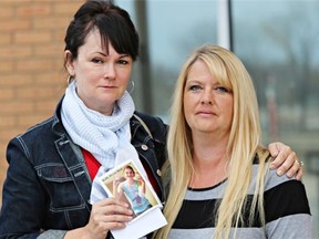 Marie Agioritis, left, holds a memorial card for her late son, Kelly Best, outside court on Monday in Saskatoon. Aigioritis lost her son to a fentanyl overdose and the son of Kim Lamb, right, still struggles with addiction to the drug. The two plan to appear in court every time someone is there on fentanyl charges.