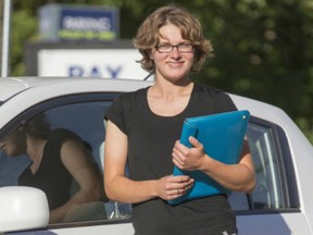 Jessie Best, co-ordinator of Saskatoon CarShare Co-op, stands in a city-designated parking stall on 12th Street East