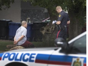 City police detained at least two people at the scene of a stabbing at 221 Ave. V. S. that took place nearby over the noon hour, July 3, 2015.