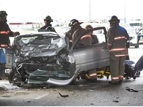 Firefighters worked to free a passenger from a car involved in a collision with a truck under the 51st overpass northbound, July 13, 2015.