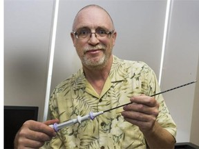 Dr. John Thiel holds an Acessa probe used for a Global Fibroid Ablation procedure, which is a less invasive approach than surgery for removing fibroids.