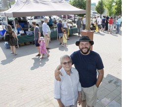 Audrey Simpkins and her son Dixon Simpkins pose for a photograph in front of their booth at the Saskatoon Farmers market