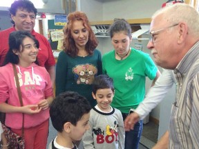 St. Philip Neri Parish parishioner Art Evoy and others welcomed the Kasarjian refugee family to their church service on Sept. 20, 2015