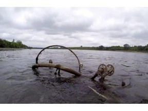 Visible from many of Saskatoon's river crossings, and covered in months - if not years - worth of vegetation, large pieces of debris ranging in size from a couch to a bicycle look like green ghosts sitting below the surface of the South Saskatchewan River.