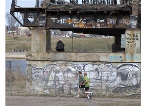 Runners out for a jog around what is left of the traffic bridge on Wednesday, April 15 in Saskatoon.