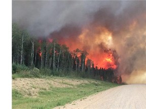 Saskatchewan Premier Brad Wall says the province's firefighting budget has been depleted, but crews will keep working in the north, where flames and smoke have forced at least 3,000 people from their homes.