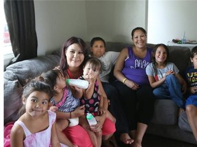 Lynette Cook, adult on left, with her children Ayzzlin, Jazmyn and Sierra with evacuee Sekwun McLeod and her children from left to right Braydon, Rebecca and Hadden on July 13, 2015 in Saskatoon.