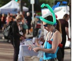 The Fringe Festival opened Thursday evening on Broadway on July 30, 2015 in Saskatoon. Balloon artist Patricia Taylor works on a creation.