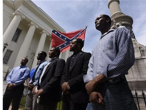 Protesters speak out against the removal of the Confederate flags from the Confederate Memorial on the state Capitol grounds in Montgomery, Ala, on June 24, 2015.