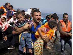 Syrian refugees arrive aboard a dinghy after crossing from Turkey to the island of Lesbos, Greece, Thursday, Sept. 10, 2015. While migrants for years have taken death-defying trips across the Mediterranean to reach the relative peace and comfort of the Europe Union, the flow has hit record proportions this year - notably with an influx of Syrians, Afghans and Eritreans fleeing trouble back home.