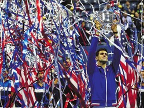 Novak Djokovic of Serbia celebrates with the winner's trophy after defeating Roger Federer of Switzerland at the U.S. Open.