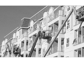 A number of workers on lift platforms were busy on a condo building on Preston Avenue on Friday.