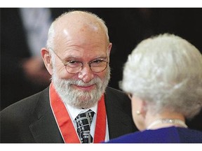 Dr. Oliver Sacks receives his Commander of the Order of the British Empire from Queen Elizabeth at Buckingham Palace in 2008. Sacks died Sunday at his home in New York City.