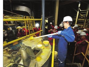 An operator at the McClean Lake uranium mill in Northern Saskatchewan checks the yellowcake mixture during processing in this 2009 file photo. The diversity of Saskatchewan's natural resources could support a turnaround in some sectors.