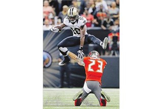 New Orleans Saints' Brandin Cooks leaps over Tampa Bay Buccaneers' Chris Conte during their game Sunday.
