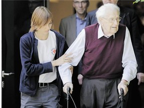 Oskar Groening, 94, leaves court Wednesday after being convicted and sentenced four years in prison for his role in the deaths of 300,000 Jews at Auschwitz.