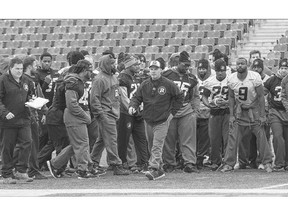 Ottawa Redblacks coach Rick Campbell heads onto the field with his players at practice in preparation for their game against the Winnipeg Blue Bombers on Friday night. The Redblacks are close to clinching a playoff spot.